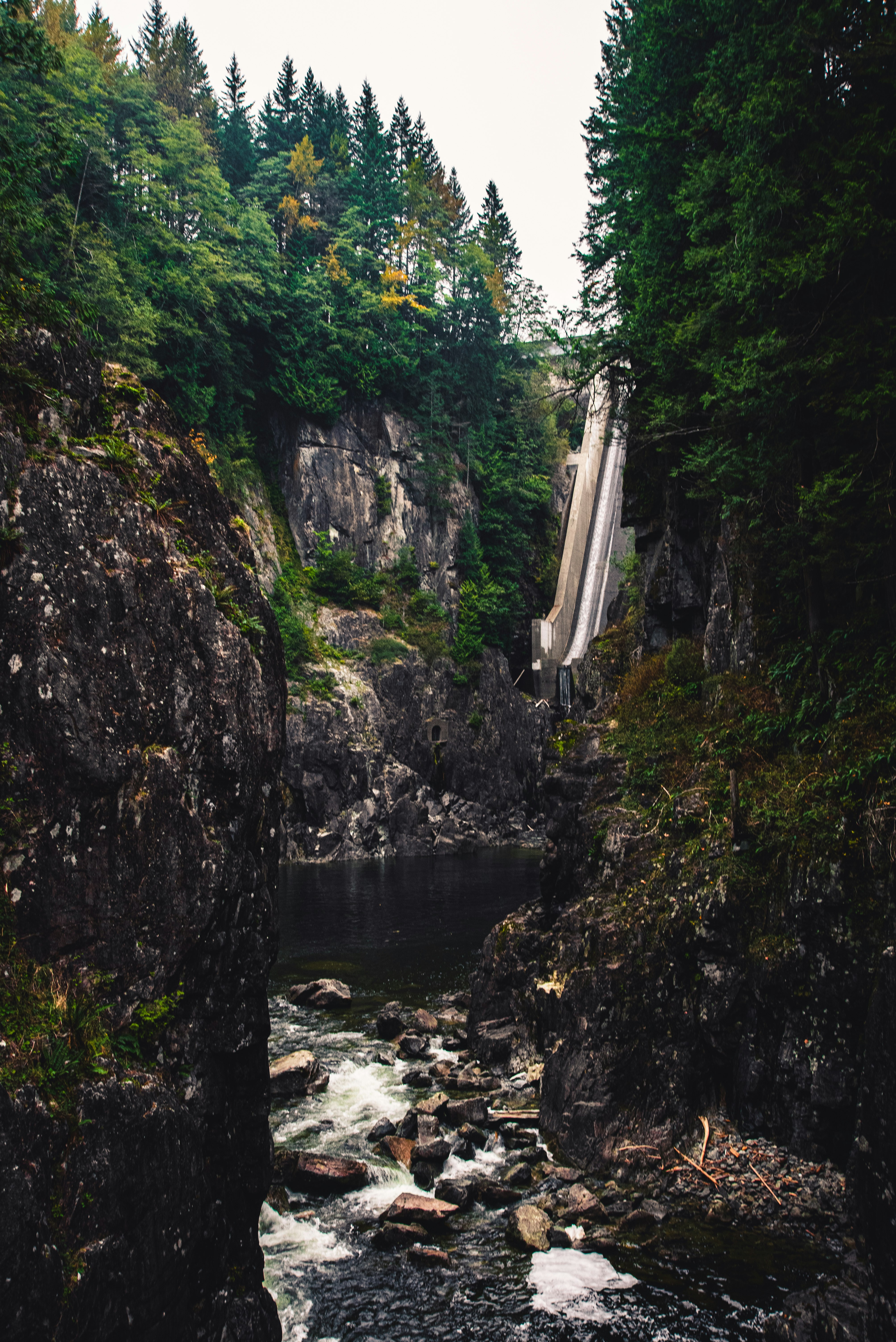 waterfalls between green moss covered rocks